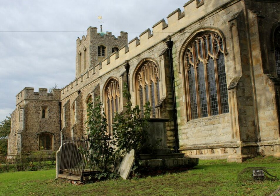 Coggeshall Church Chris Heaton The exterior of a pale yellow stone church with extremely large perpendicular windows and a low, flint tower