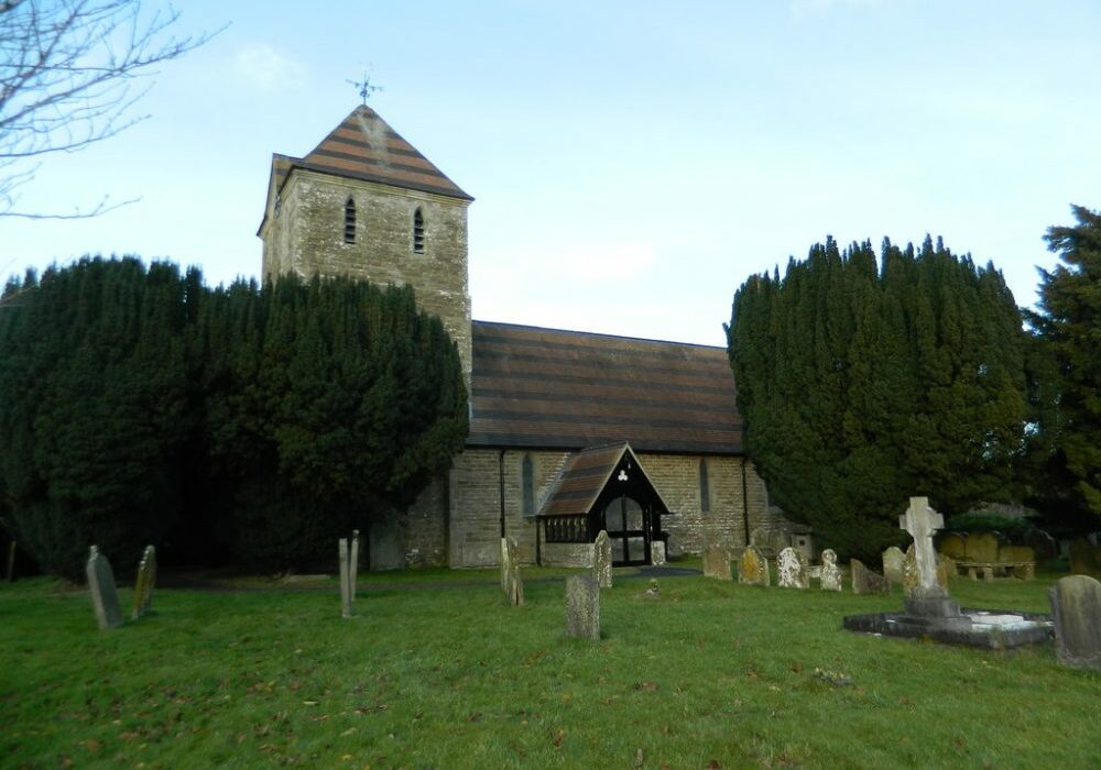 St Andrew, Hope Bowdler south John Lord Stone church with bell tower and black and red roof tiles in a striped pattern