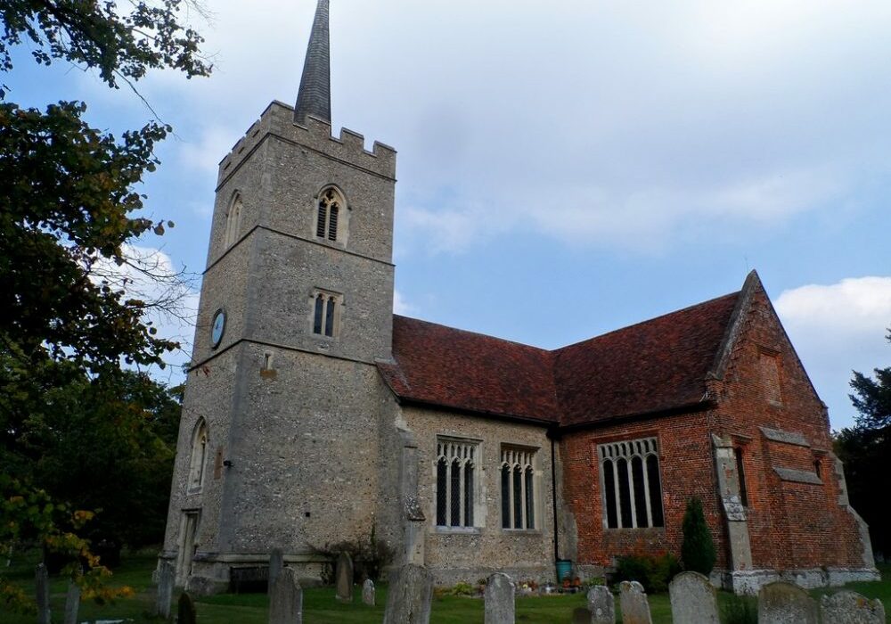 St Dunstan, Hunsdon, south side Stone tower and nave with brick South Chapel and gravestones in foreground