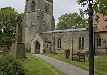 Low Catton south porch Paul Harrop Exterior of stone church from south with iron lampost beside path leading to south porch