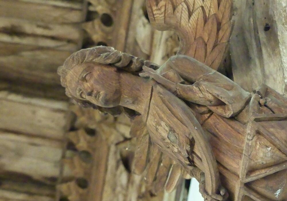 ChurchImages Suffolk Wetherden Roof Angel 2 A carved angel holding a shield supporting the roof of the church