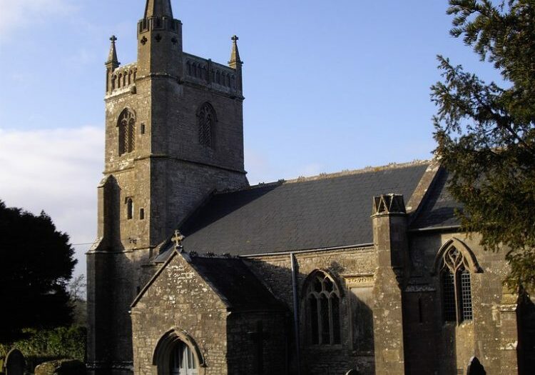 The Blessed Virgin Mary, Nempnett Thrubwell, Somerset - John Lord Stone church as sun is setting with shadows and yew trees
